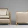 A pair of sculpted and gilt Art Deco armchairs