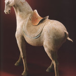 A massive pottery figure of a saddled horse