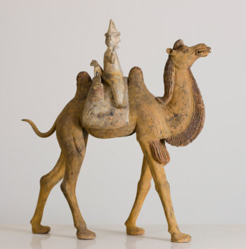 Pottery figure of Bactrian camel with foreign rider and dog on saddle