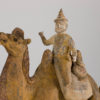 Pottery figure of Bactrian camel with foreign rider and dog on saddle