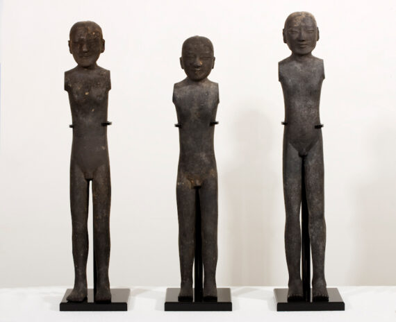 A set of three pottery standing figures