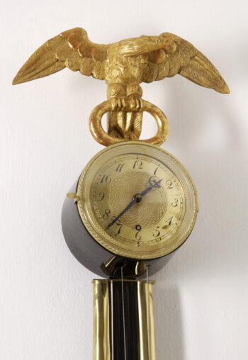 An unusual Empire wall clock
