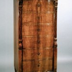 A Biedermeier seven drawer tall chest of drawers
