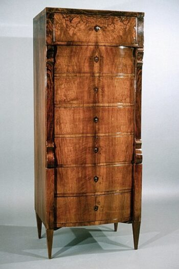 A Biedermeier seven drawer tall chest of drawers