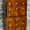 A Biedermeier seven drawer tall chest of drawers