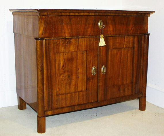 A Biedermeier two door commode with a single drawer