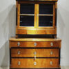 A Biedermeier three drawer commode with vitrine top