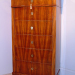 A Biedermeier six drawer tall chest