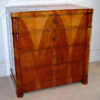 A fine and unusual Biedermeier four drawer commode with folding mirror in top drawer