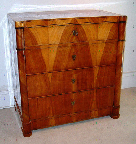 A fine and unusual Biedermeier four drawer commode with folding mirror in top drawer