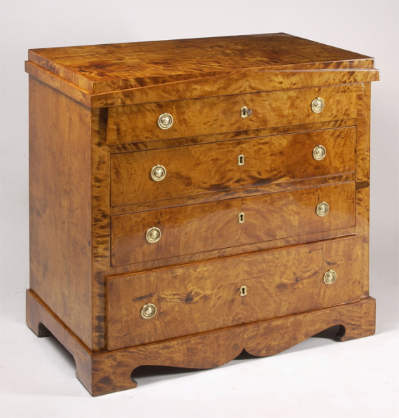 A petite Biedermeier four-drawer commode