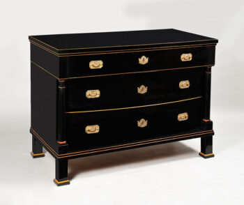 A three-drawer, ebonized Biedermeier commode