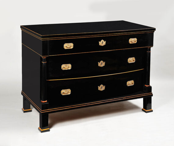 A three-drawer, ebonized Biedermeier commode