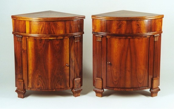 A pair of Neoclassical corner console tables