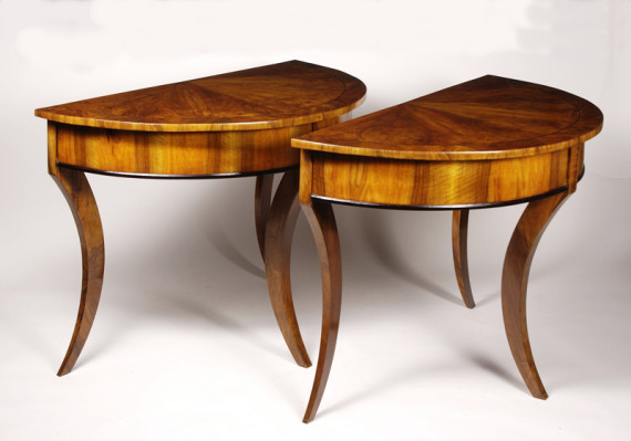 A pair of Biedermeier demi-lune console tables