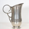 A hammered pewter pitcher by R. DeLavan
