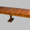 A Biedermeier double pedestal extendable dining table