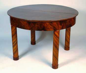 A Biedermeier extendable dining table with diagonally banned legs and cross banded details