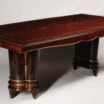 An extendable dining table in the manner of Jules Leleu