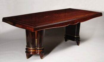 An extendable dining table in the manner of Jules Leleu
