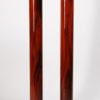 A modernist style display pedestal in rosewood with ebonized detail