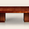 An extendable dining table with fluted base by ILIAD Design