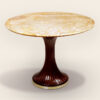 A petite pedestal table by ILIAD Design
