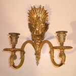 A pair of Neoclassical two-arm sconces with the image of Bacchus