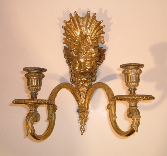 A pair of Neoclassical two-arm sconces with the image of Bacchus