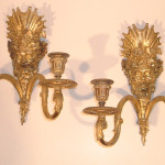 A pair of Neoclassical two-arm sconces with the image of Bacchus
