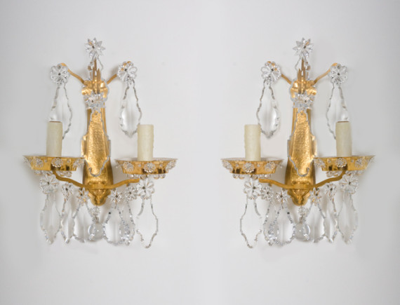A pair of gold-plated Baccarat sconces