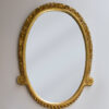 A carved and gilt wall mirror by Maurice Dufrene
