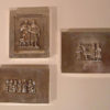 Three small silverplate cigarette boxes with figural reliefs