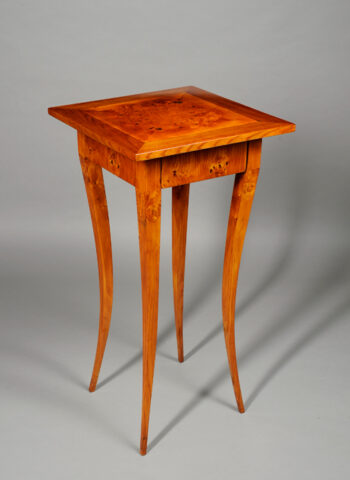 A Biedermeier sabre leg side table