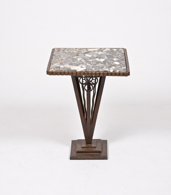 An elegant forged iron and marble side table attributed to Paul Kiss