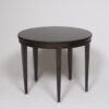 An ebonized occasional table by Jacques Adnet