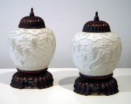 A fine pair of bisque overlay porcelain jars with rosewood covers and stands 2