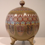 A global shaped footed vase with cover