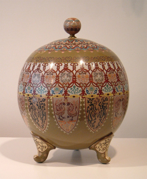 A global shaped footed vase with cover