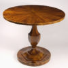 A petite Biedermeier tilt top pedestal table