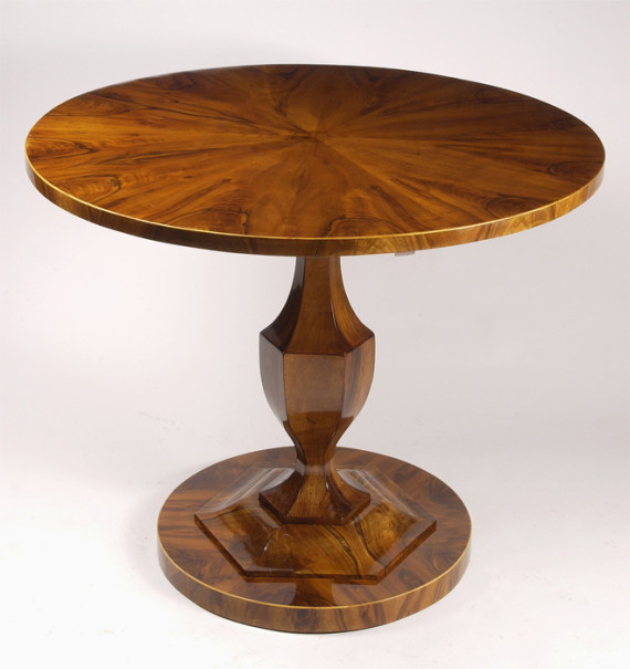 A petite Biedermeier tilt top pedestal table