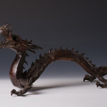 A bronze okimono of a dragon