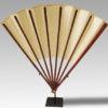 A gold-speckled Fan with bamboo fan guards with circular head and bone domed boss with a metal rivet
