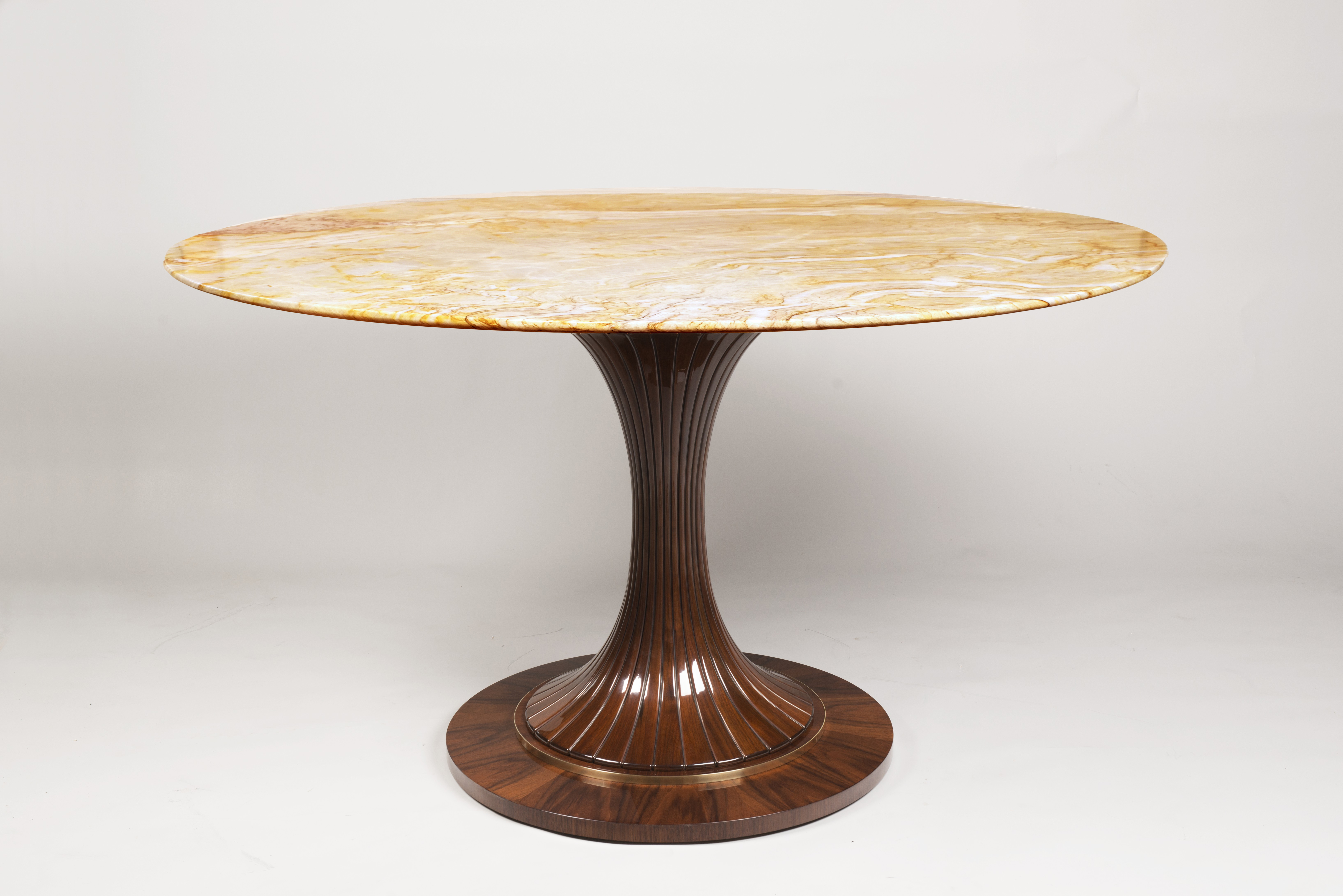 An Oval Pedestal Table by ILIAD Design Iliad